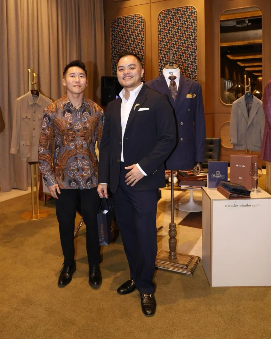 Guests at the Laxmi Tailors bespoke booth beside a navy double-breasted suit at Prestige 40 Under 40, 25hours Hotel Jakarta