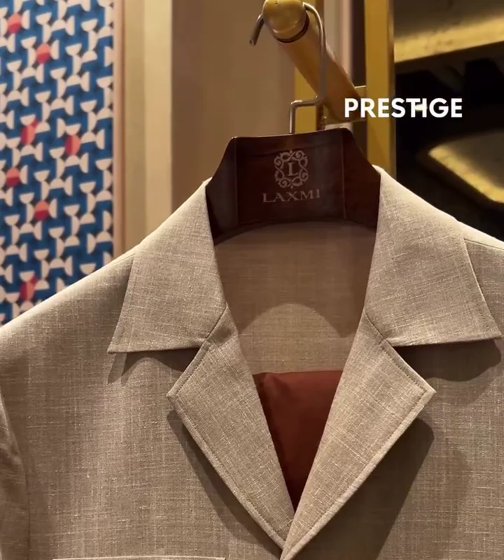 Laxmi bespoke safari jacket in linen-look cloth on a Laxmi hanger at the Prestige 40 Under 40 booth