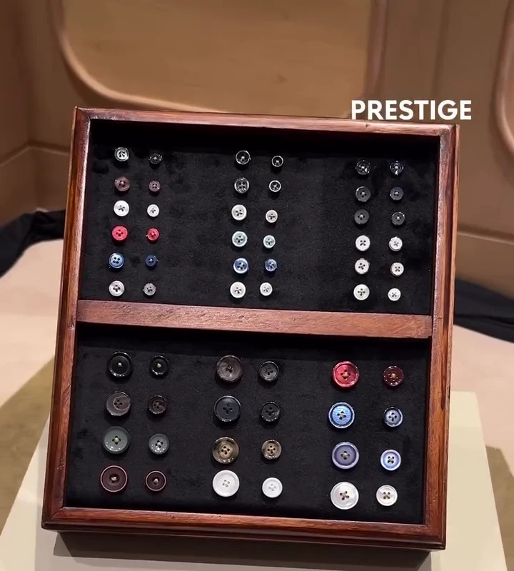 Walnut tray of suit and shirt buttons at the Laxmi Tailors bespoke booth, Jakarta