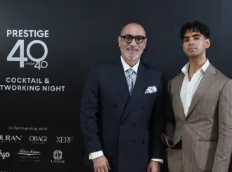 Dalip Shahri of Laxmi Tailors in a navy double-breasted bespoke suit with a guest at the Prestige Indonesia 40 Under 40 Cocktail & Networking Night, 25hours Hotel Jakarta